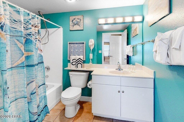 full bathroom featuring shower / tub combo with curtain, vanity, toilet, and tile patterned floors