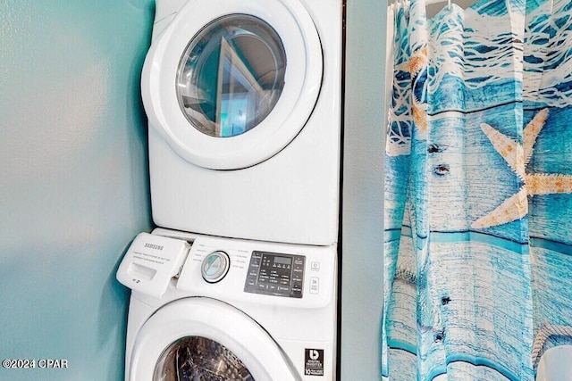 laundry area featuring stacked washer / dryer