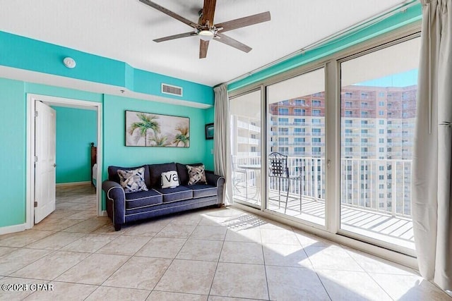 tiled living room featuring plenty of natural light and ceiling fan