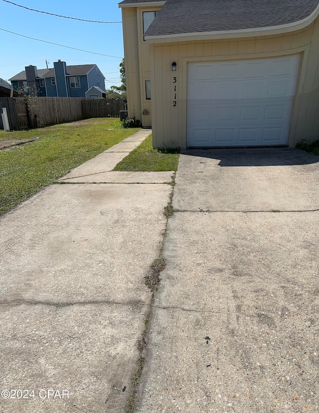 garage featuring a lawn