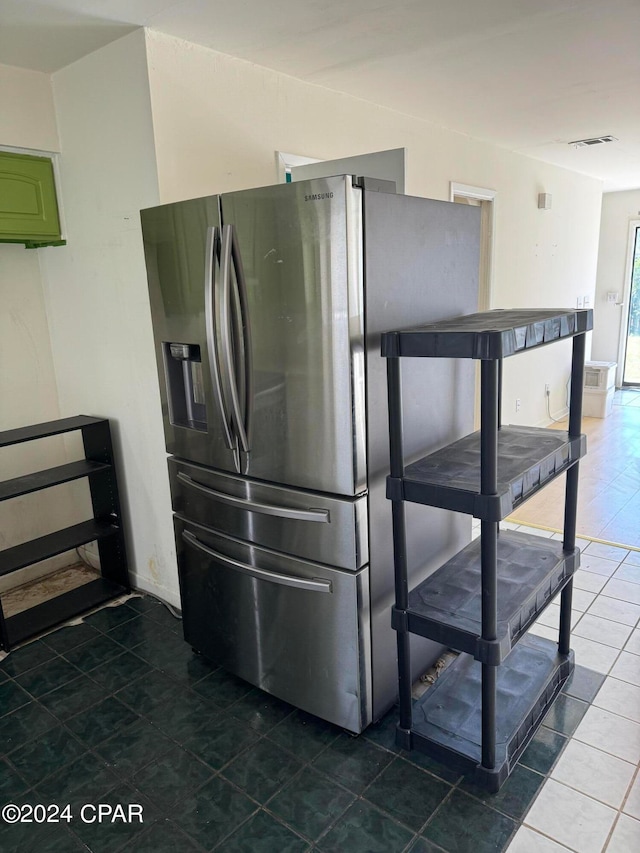 kitchen featuring tile patterned floors and stainless steel fridge with ice dispenser