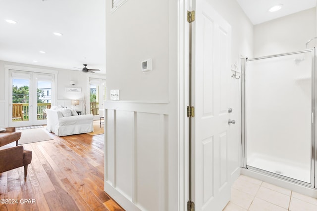 corridor with recessed lighting, french doors, and light wood finished floors