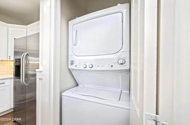 clothes washing area with laundry area and stacked washer / drying machine