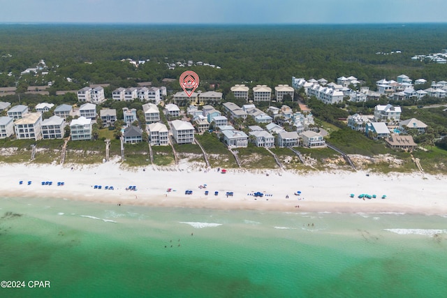 birds eye view of property with a view of the beach and a water view