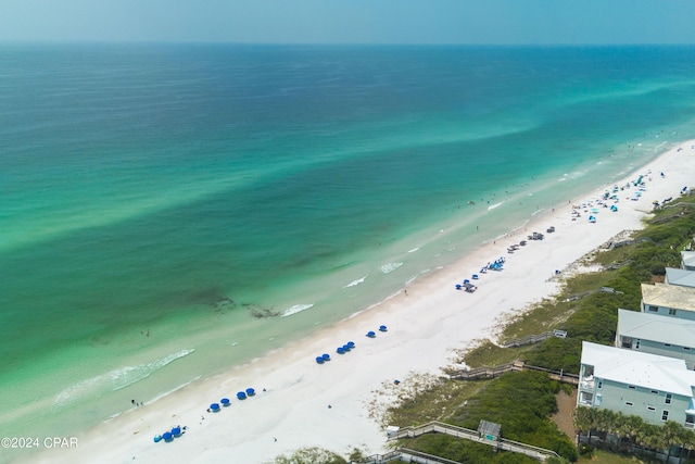 birds eye view of property featuring a beach view and a water view