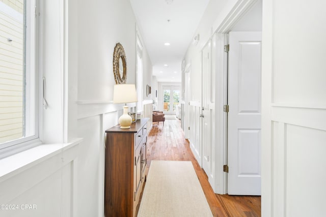 hall with light wood-type flooring and recessed lighting