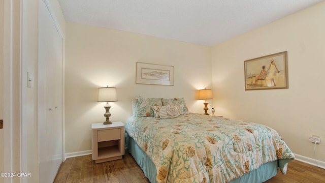 bedroom with hardwood / wood-style floors and a closet