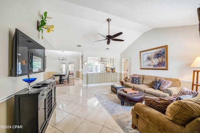 living room featuring french doors, a textured ceiling, light tile patterned floors, lofted ceiling, and ceiling fan