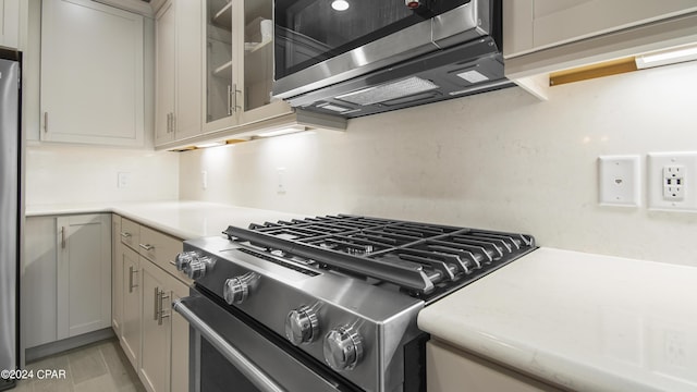 kitchen with gray cabinetry and stainless steel appliances