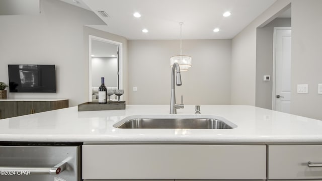 kitchen with sink, decorative light fixtures, white cabinets, and dishwasher