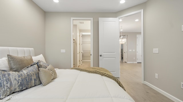 bedroom featuring hardwood / wood-style floors and ensuite bathroom