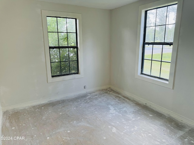 spare room featuring a healthy amount of sunlight and concrete floors