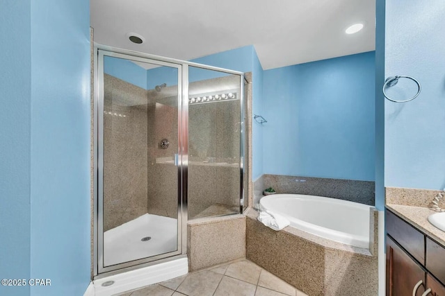 bathroom featuring tile patterned flooring, vanity, and separate shower and tub