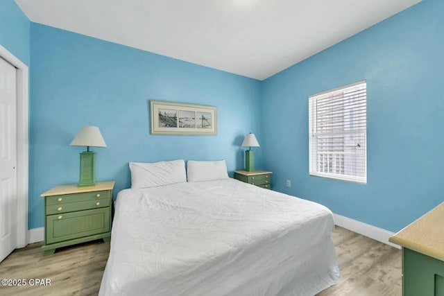 bedroom with a closet and light hardwood / wood-style flooring