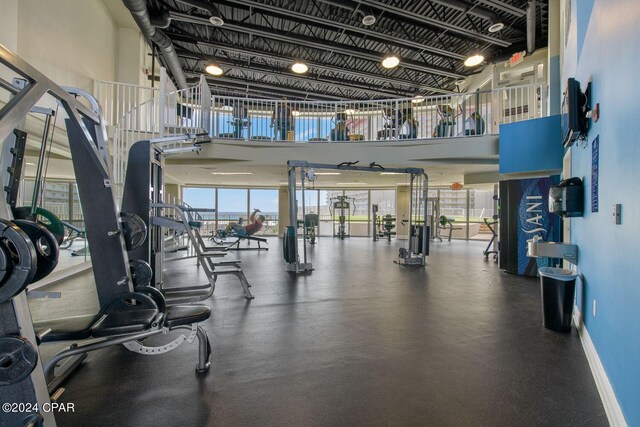 workout area featuring a towering ceiling