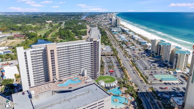 drone / aerial view featuring a water view and a beach view