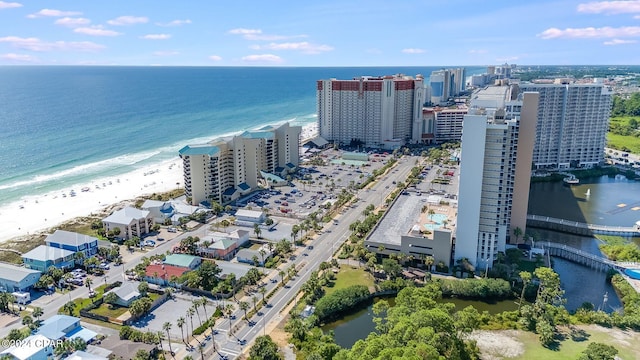 drone / aerial view featuring a water view and a beach view