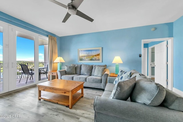 living room featuring ceiling fan and light wood-type flooring