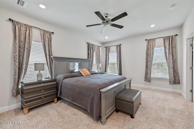 bedroom with visible vents, baseboards, light colored carpet, recessed lighting, and a ceiling fan