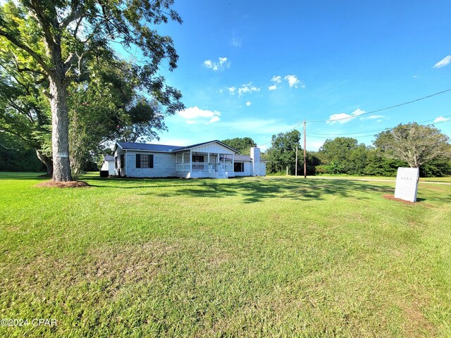 view of front of property with a porch and a front lawn