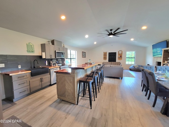 kitchen featuring gray cabinets, appliances with stainless steel finishes, sink, and light hardwood / wood-style floors