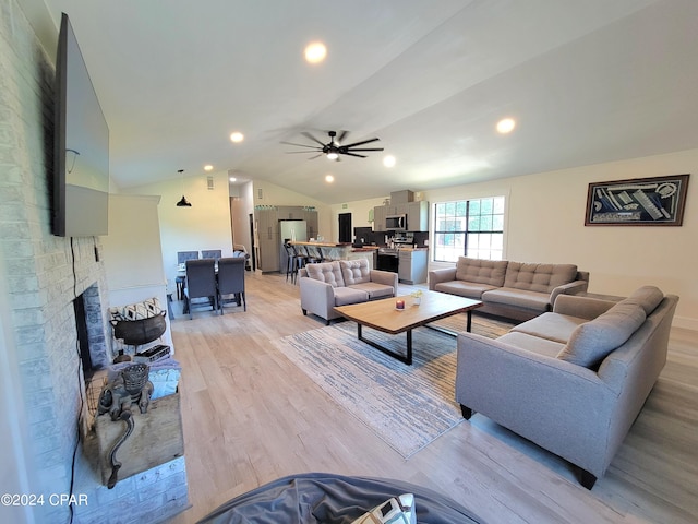 living area with lofted ceiling, ceiling fan, recessed lighting, a fireplace, and light wood-style floors