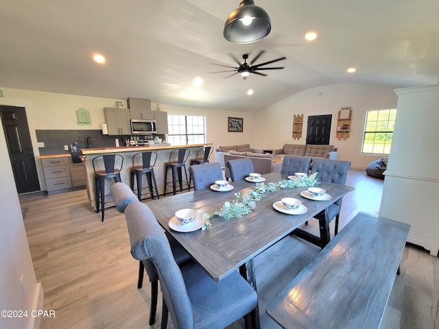 dining room with vaulted ceiling, light wood finished floors, a ceiling fan, and recessed lighting