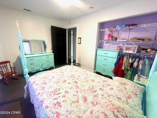 bedroom featuring visible vents and baseboards