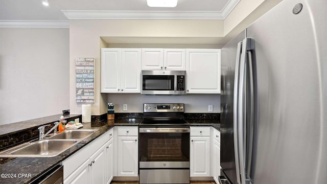 kitchen with white cabinetry, stainless steel appliances, crown molding, and sink