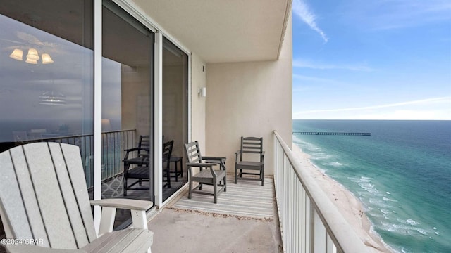 balcony with a view of the beach and a water view