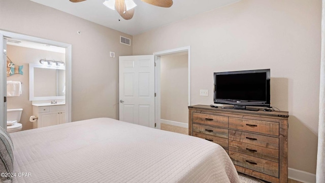 bedroom with ensuite bathroom and ceiling fan