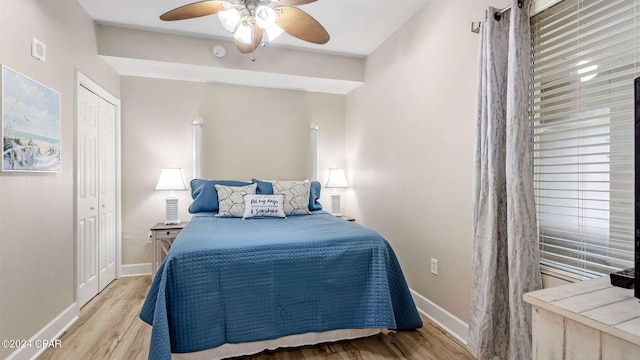 bedroom featuring ceiling fan, light hardwood / wood-style floors, and a closet