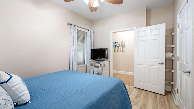 bedroom with ceiling fan and light wood-type flooring