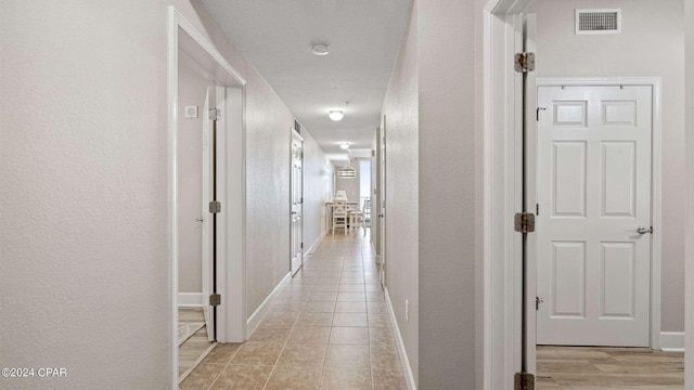 corridor with light tile patterned floors