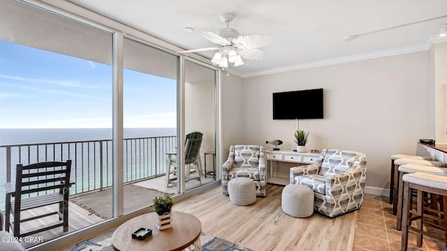 living room with ceiling fan, light hardwood / wood-style flooring, and crown molding