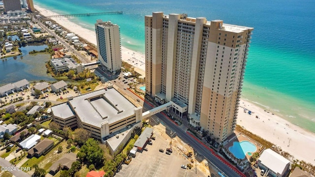 drone / aerial view featuring a water view and a beach view