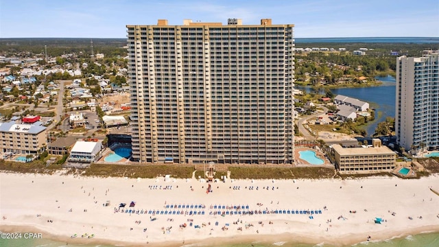 drone / aerial view featuring a water view and a beach view