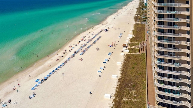 drone / aerial view with a water view and a beach view