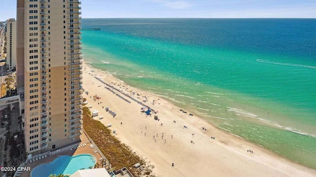 birds eye view of property with a water view and a view of the beach