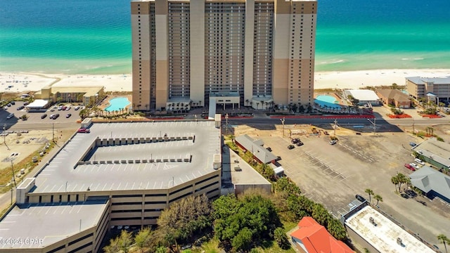 aerial view with a water view and a beach view