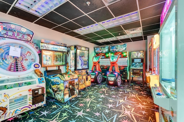 recreation room featuring a paneled ceiling