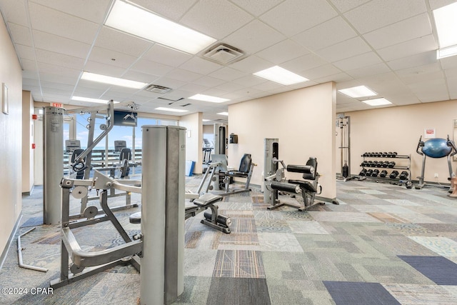 workout area featuring a paneled ceiling and carpet flooring