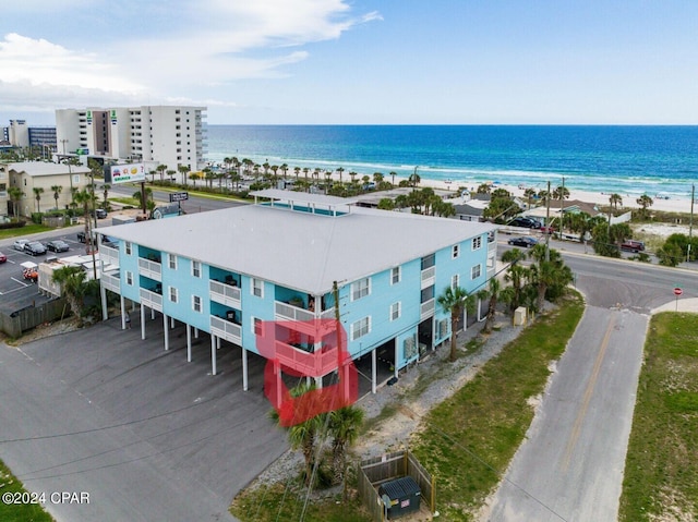 birds eye view of property featuring a water view and a beach view