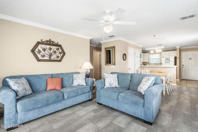 living room with ceiling fan, a textured ceiling, crown molding, and light tile patterned floors