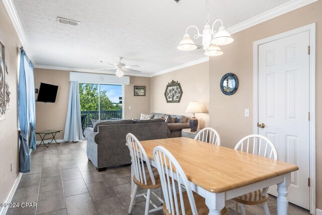 dining area featuring ceiling fan with notable chandelier, crown molding, a textured ceiling, and tile patterned floors