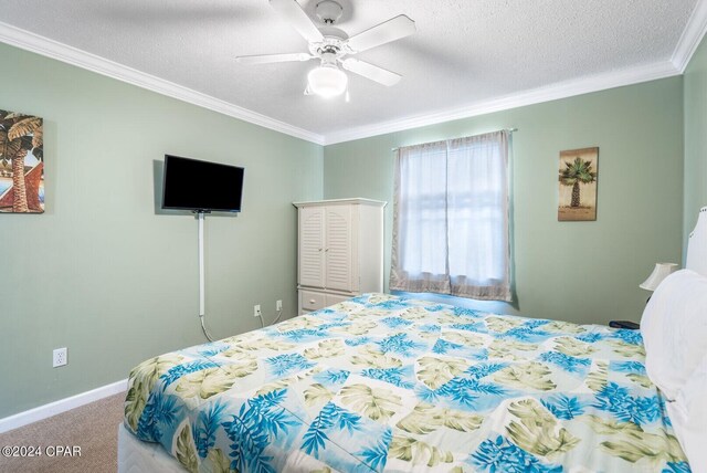 carpeted bedroom with ceiling fan, crown molding, and a textured ceiling