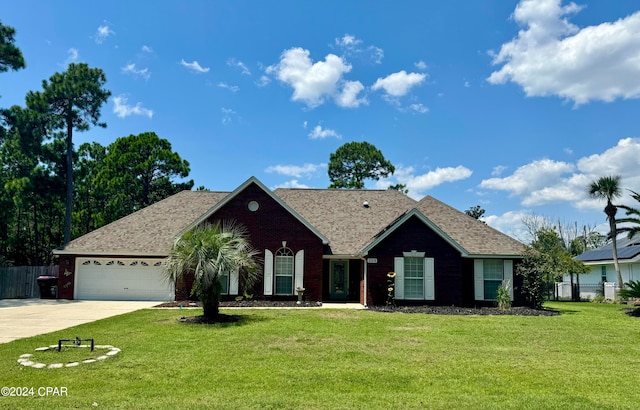 ranch-style home featuring a garage and a front lawn