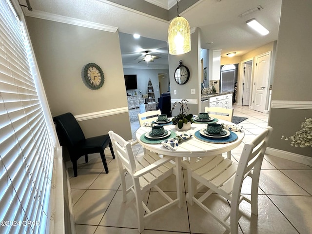 dining area with ceiling fan, light tile patterned floors, and ornamental molding