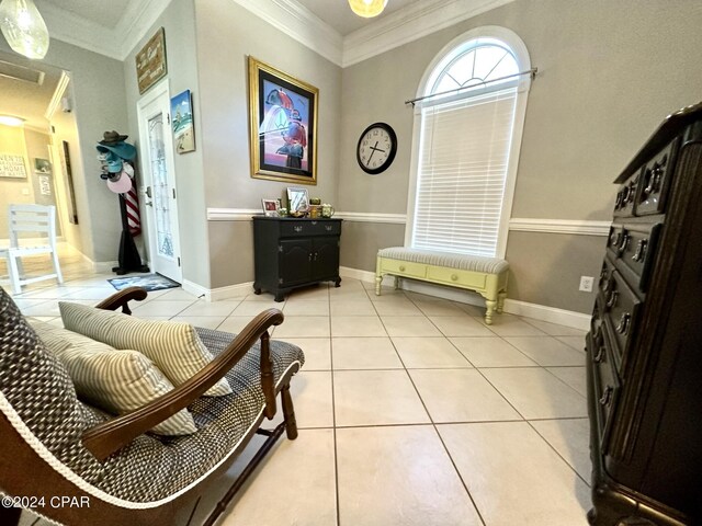 sitting room featuring light tile patterned floors and crown molding