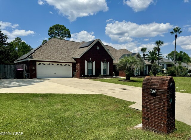 ranch-style house featuring a front yard and a garage